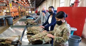 Dr. Daniel Mountjoy (left), Christine Villa, and Maj. Saily Rodriguez, with the Air Force Life Cycle Management Center's Human Systems Division, perform an inspection on new body armor units designed specifically for female Airmen in Security Forces