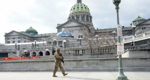 A soldier walks along his patrol at the capitol complex in Harrisburg, Pa., on Jan. 17, 2021.