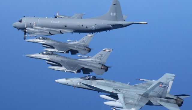 NORAD assets from the US Air Force and Royal Canadian Air Force fly in formation