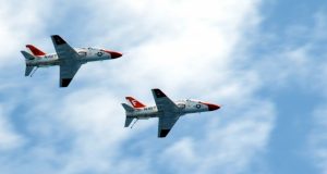 T-45 Goshawk training aircraft assigned to Training Air Wing ONE fly over the aircraft carrier USS George H.W. Bush in 2010 to mark one million flight hours. George H.W. Bush is conducting training in the Atlantic Ocean.