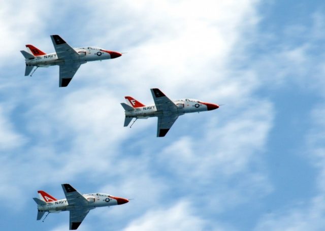 T-45 Goshawk training aircraft assigned to Training Air Wing ONE fly over the aircraft carrier USS George H.W. Bush in 2010 to mark one million flight hours. George H.W. Bush is conducting training in the Atlantic Ocean.