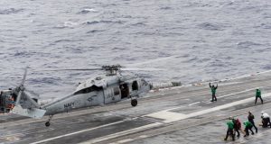 An MH-60S Sea Hawk helicopter assigned to the Chargers of Helicopter Sea Combat Squadron (HSC) 26 takes off from the flight deck of the aircraft carrier USS Theodore Roosevelt (CVN 71).