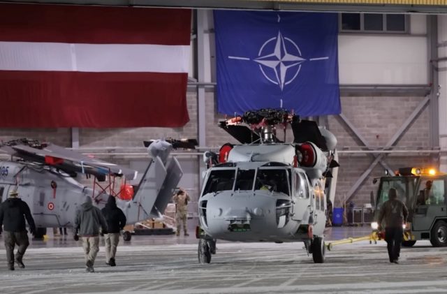 Latvian Black Hawk helicopters in a hangar